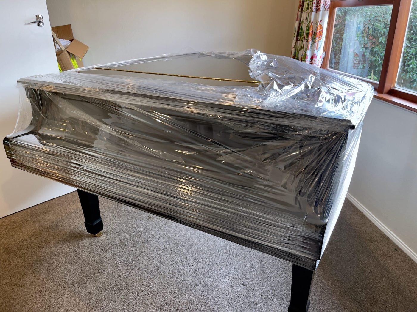 Grand piano wrapped and protected, ready for secure storage