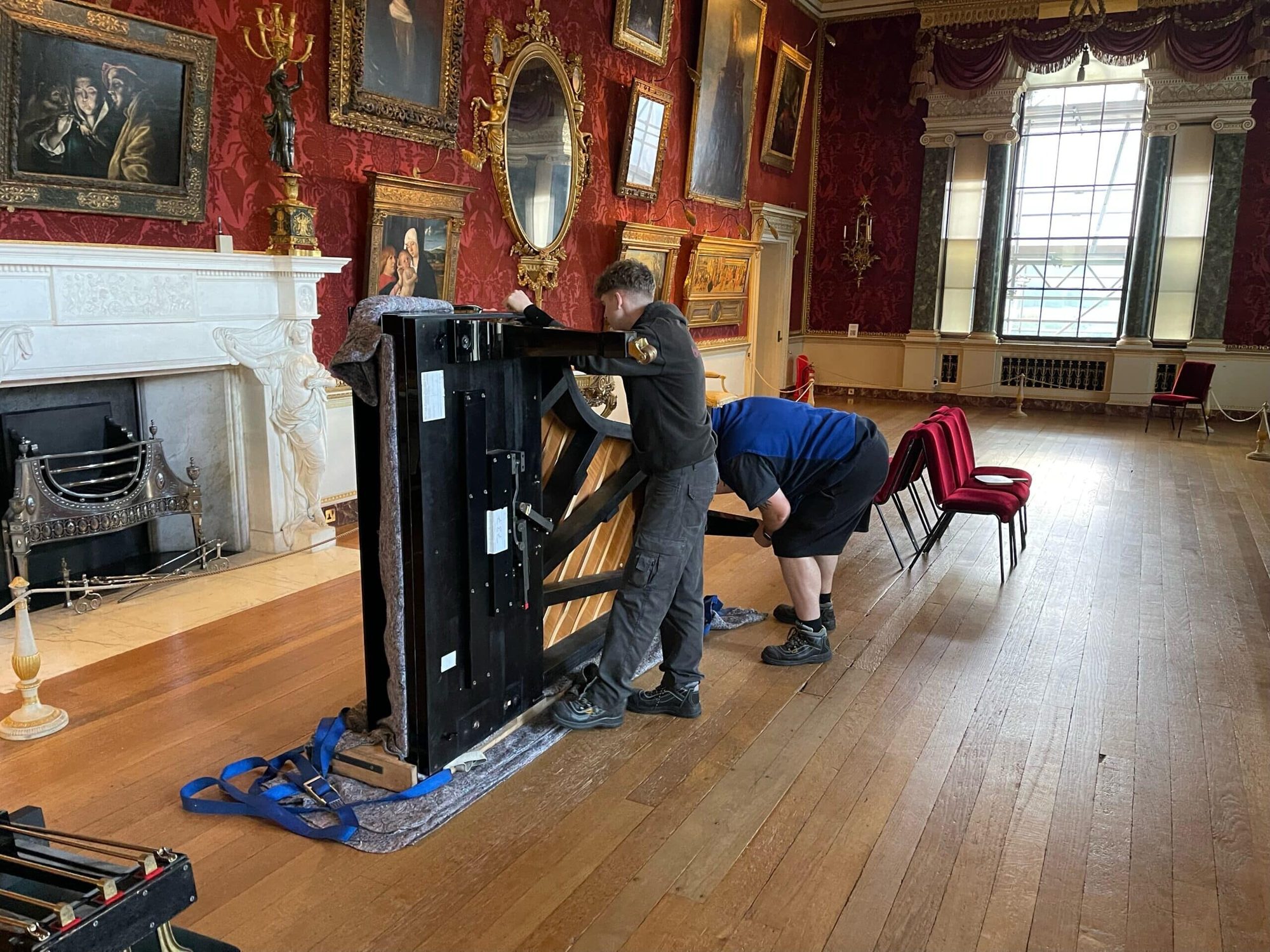 Yorkshire Piano Logistics team moving a grand piano in an opulent Yorkshire state room